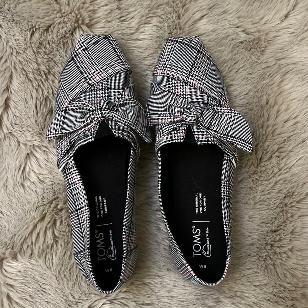 Brand new TOMS shoes that were worn inside the house only.